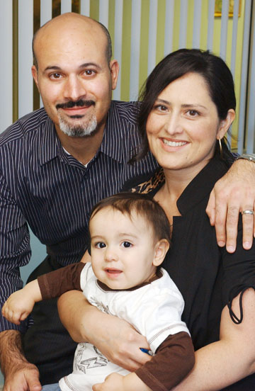 Chiropractors Andrea and Jesse Shakarian, who opened their business in Pacific Palisades in December, hold their son Zane.